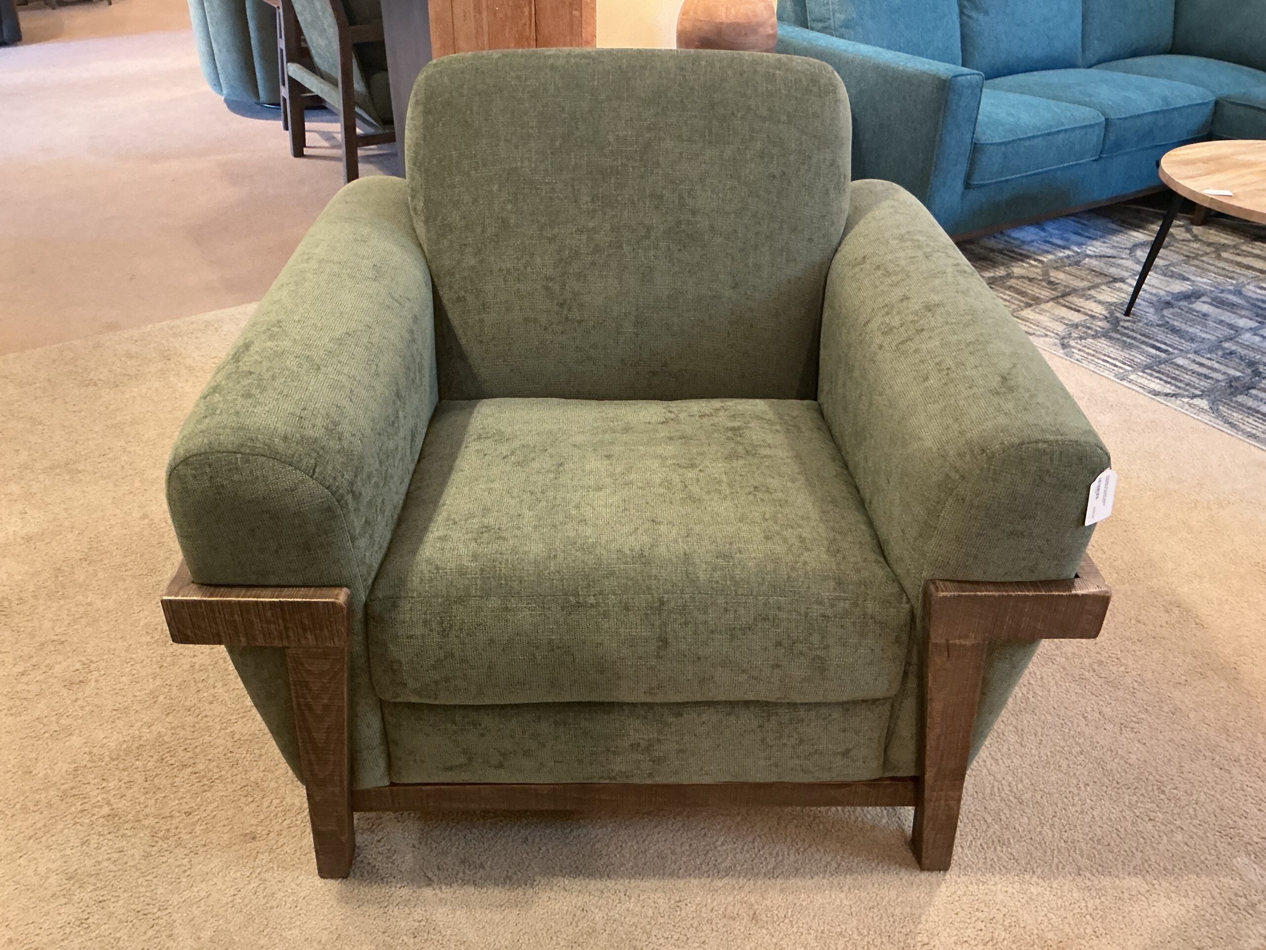 wooden framed green armchair