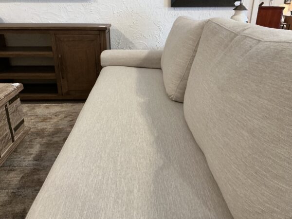 light colored wooden framed base sofa